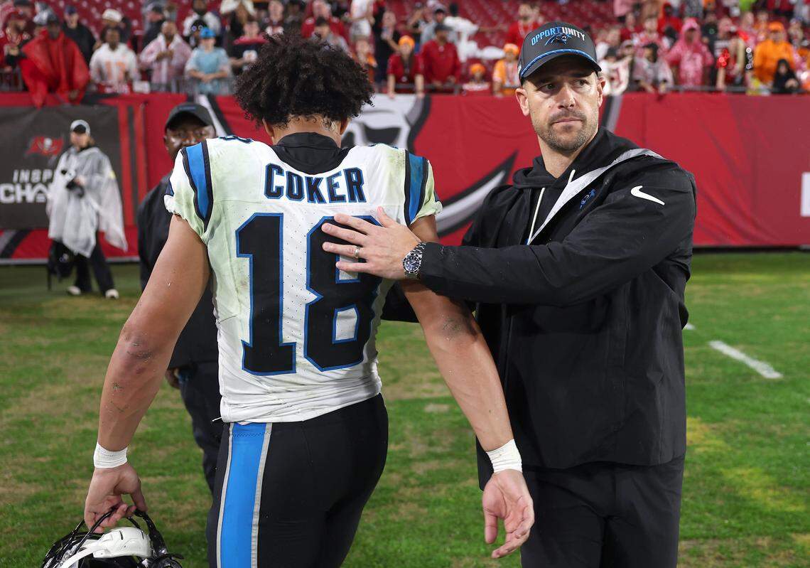 Carolina Panthers wide receiver Jalen Coker, left, is consoled by head coach Dave Canales following the team’s 16-14 loss to the Tampa Bay Buccaneers at Raymond James Stadium in Tampa, FL.on Saturday, January 3, 2026. 
