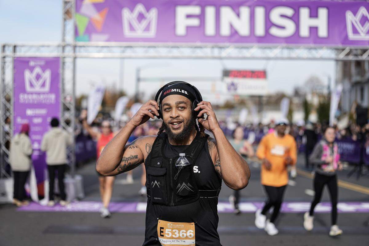 A participant smiles after competing in the Novant Health Charlotte Marathon Saturday, Nov. 15, 2025, in Charlotte, N.C.