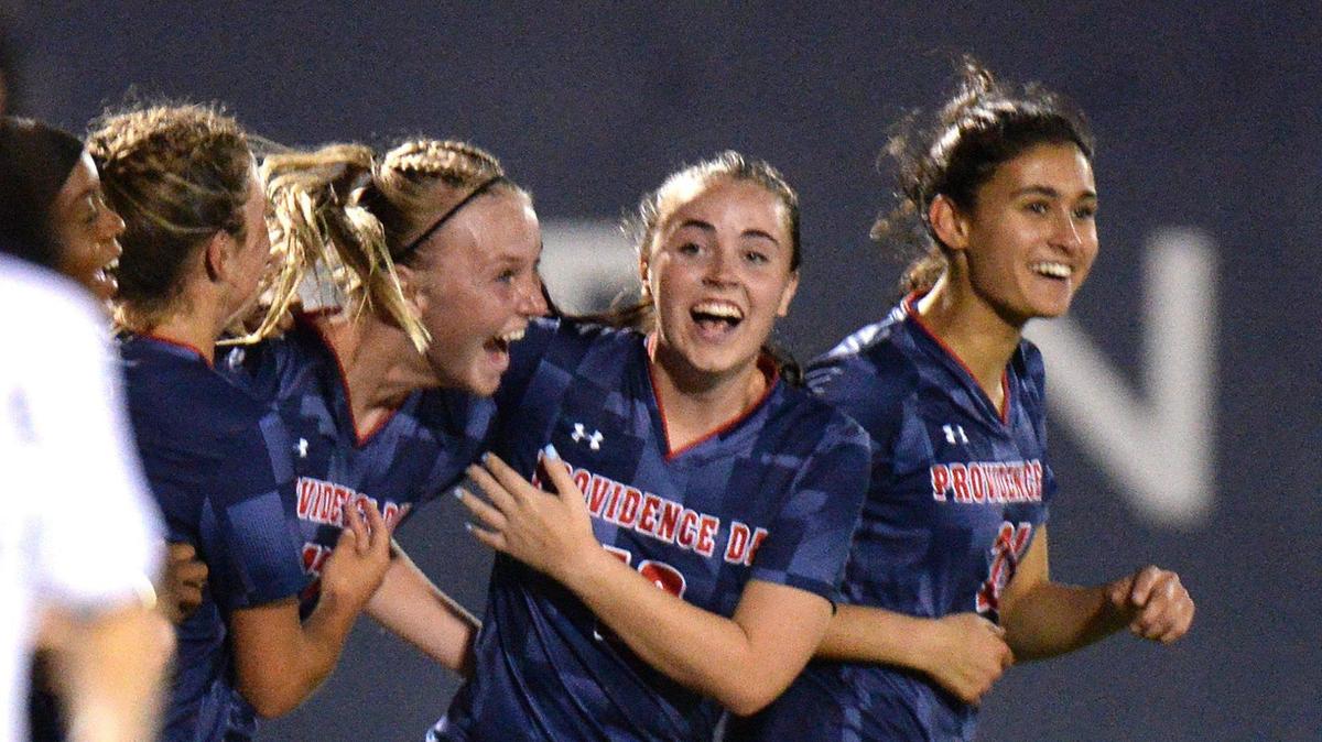 Providence Day midfielder #17 Blane McElroy (second from left) is congratulated by teammates after she scored the third goal for the Chargers as they took a 3-0 lead in the second half. Unbeaten Charlotte Latin visits unbeaten Providence Day for a much anticipated girls soccer match. Both teams are ranked among the nation’s top 10. They faced off on Tuesday, April 2, 2024.
