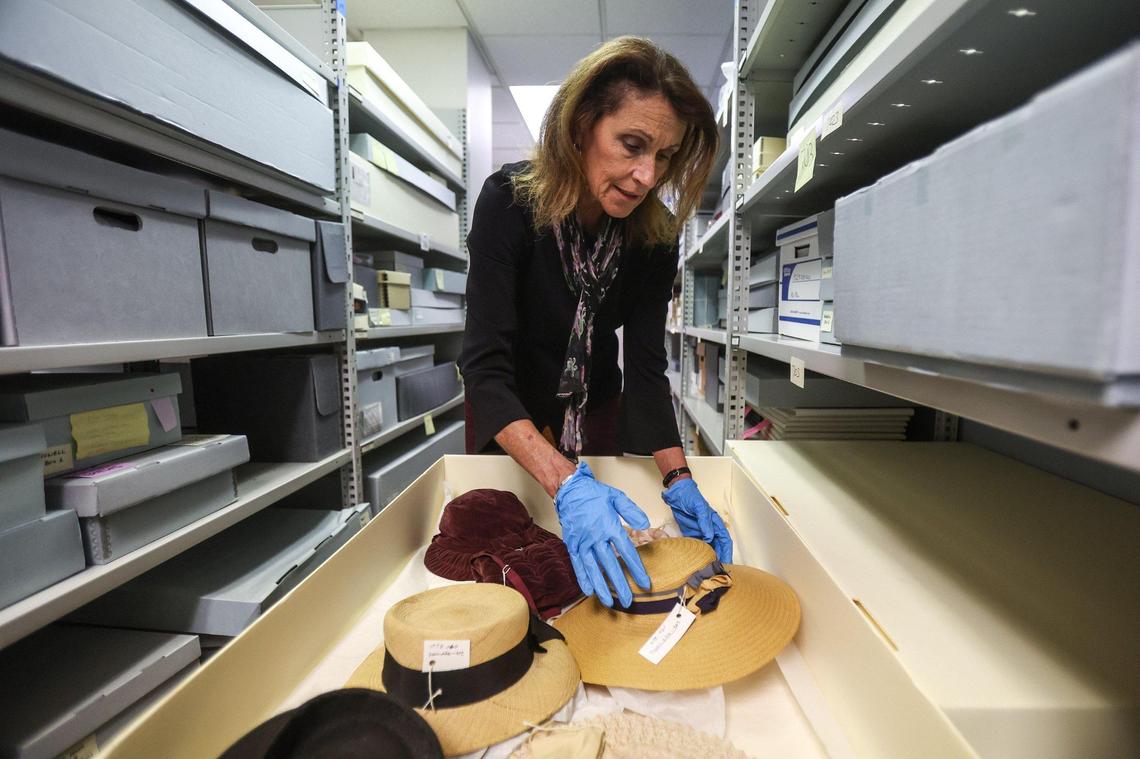 Kathryn Hill examines hats in a storage box in the new office of Levine Museum of the New South in Charlotte. “The work ahead of us now,” said Hill, the museum’s CEO, “is looking at each of these objects and making sure they’re documented, that we know what they are and that we have physical and intellectual control over them.”