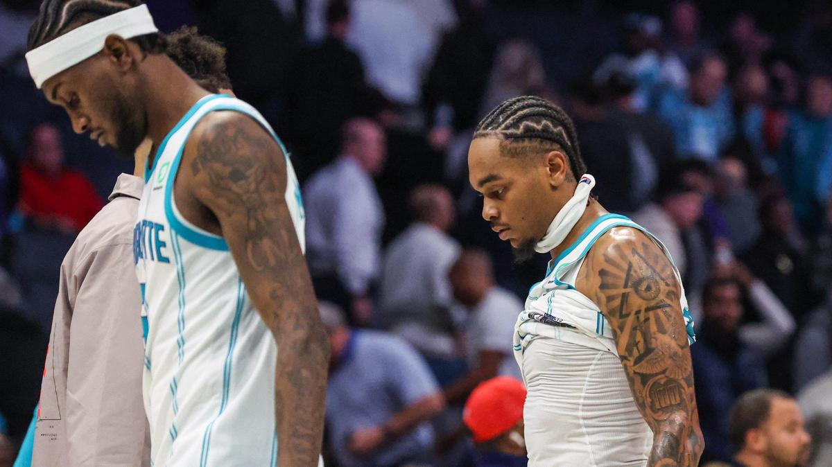 The Hornets’ Jalen McDaniels, left, and PJ Washington hang their heads as they walk to the locker room after the Hornets lost to the Trail Blazers, 105-95, at Spectrum Center on Wednesday, November 9, 2022.