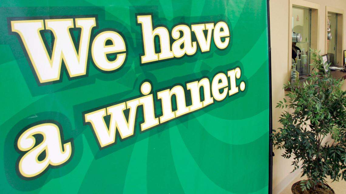 The mom stopped to buy the biscuit and the ticket on the way to work. (AP Photo/Chuck Burton)