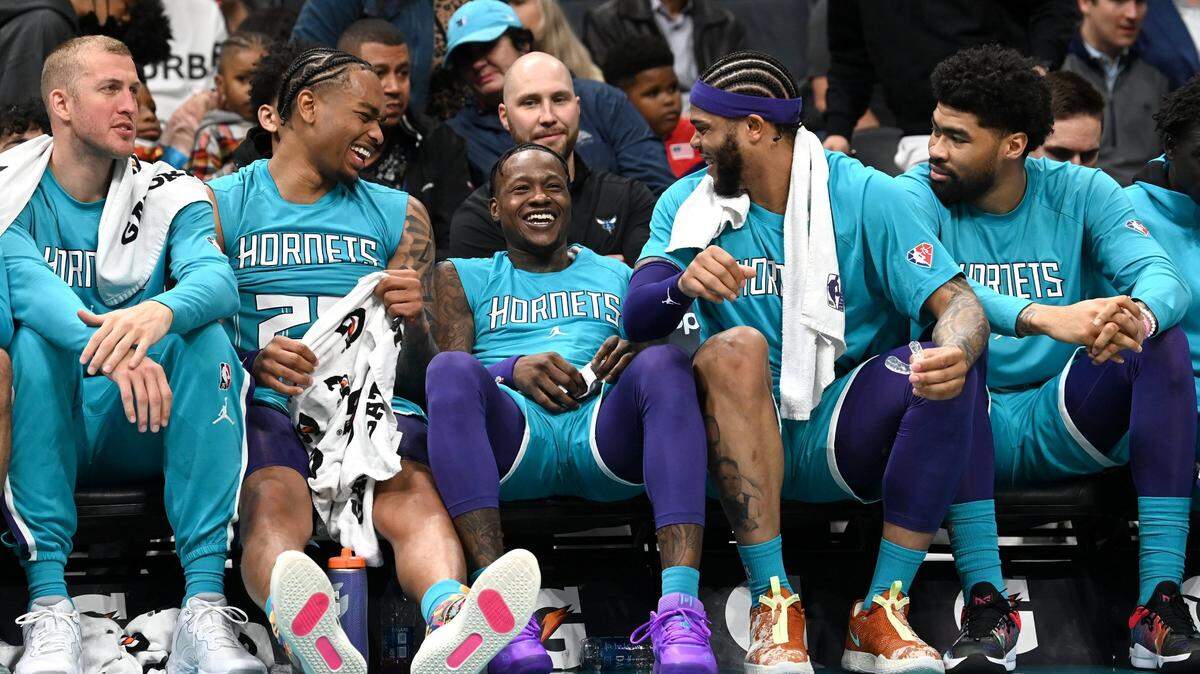 Members of the Charlotte Hornets react following a dunk by center Montrezl Harrell during first half action against the Atlanta Hawks at Spectrum Center in Charlotte, NC on Wednesday, March 16, 2022.