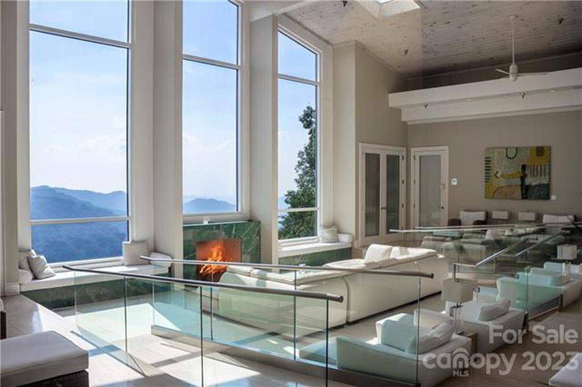 The property includes three primary residences with views of Johns River Gorge, stretching to the Charlotte skyline, and Grandfather Mountain.