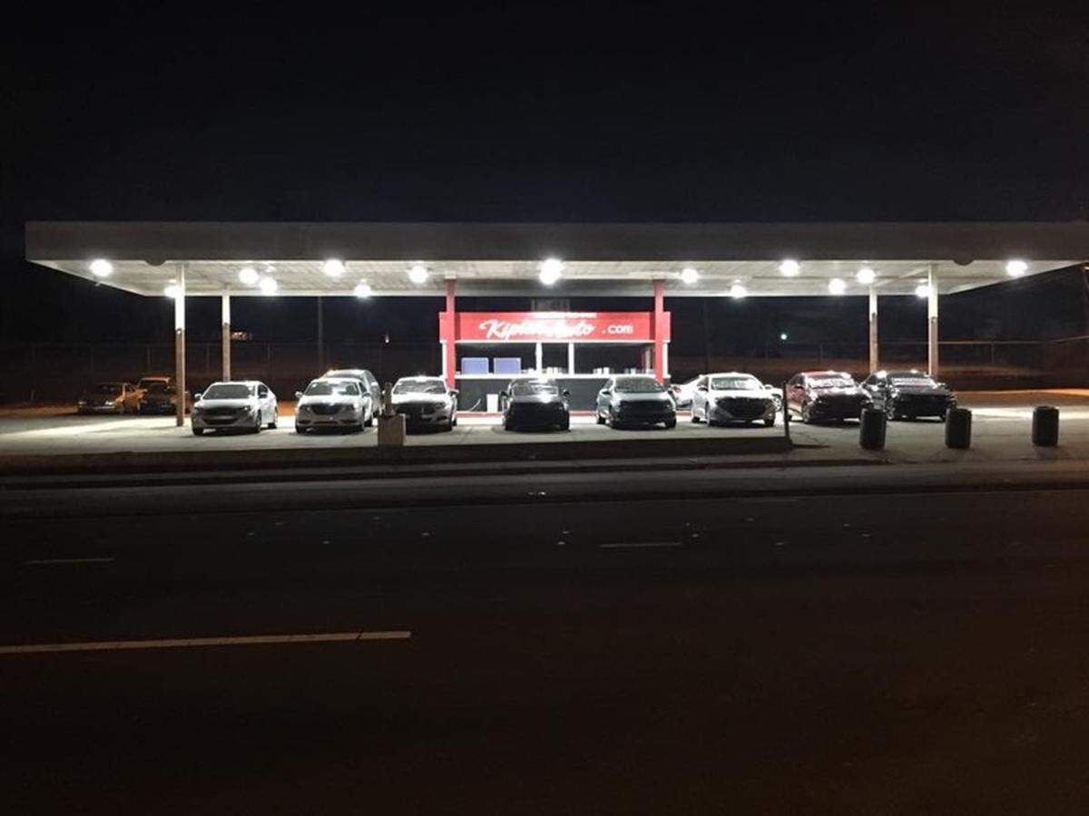 Kiplin Automotive Group on Brookshire Boulevard in Charlotte is pictured at night with cars for sale. The brightness of the lot provides a measure of safety for homeless people who are invited to drive onto the lot to spend the night, general manager Charles James says.