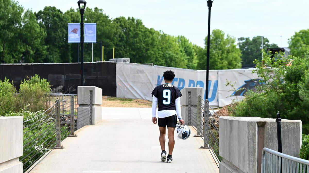 Carolina Panthers quarterback Bryce Young walks to the team’s voluntary minicamp practice on Wednesday, April 24, 2024.