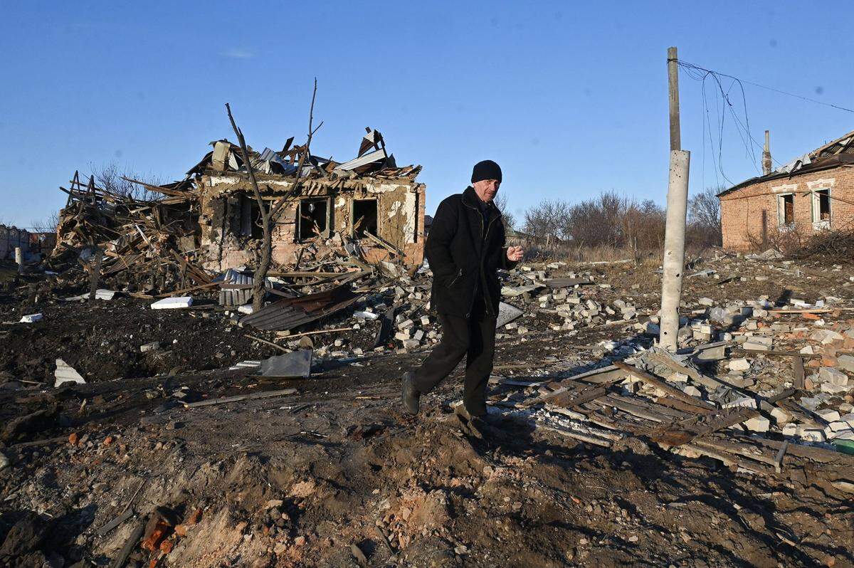 A man walks near a destroyed private house after the explosion of an aerial guided bomb in Kharkiv region on Feb. 24, 2025, on the third anniversary of Russia’s full-scale invasion of Ukraine.