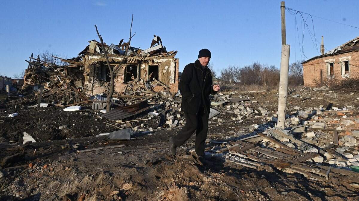 A man walks near a destroyed private house after the explosion of an aerial guided bomb in Kharkiv region on Feb. 24, 2025, on the third anniversary of Russia’s full-scale invasion of Ukraine. (Sergey Bobok/AFP/Getty Images/TNS)