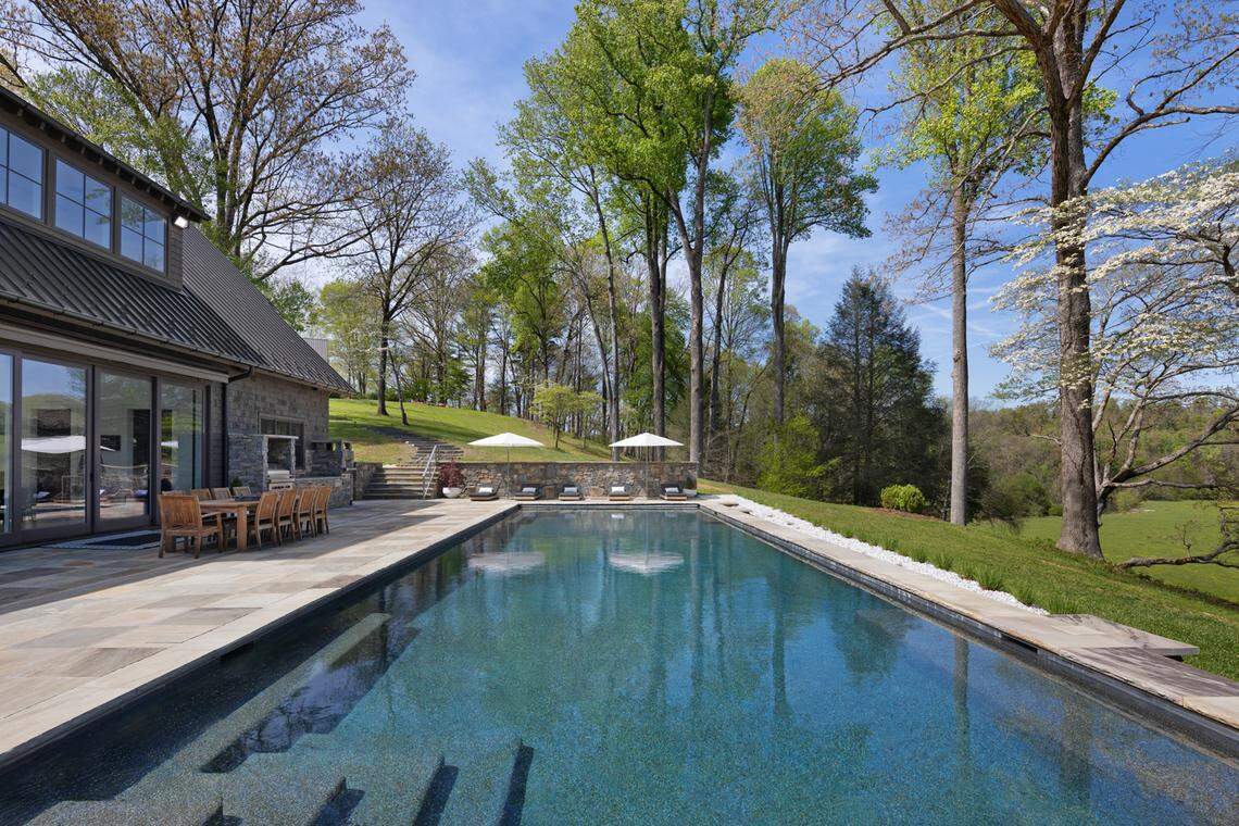 The property also features a heated pool, private gym, home theater, tennis court, greenhouse, three spring-fed ponds and miles of wooded trails.