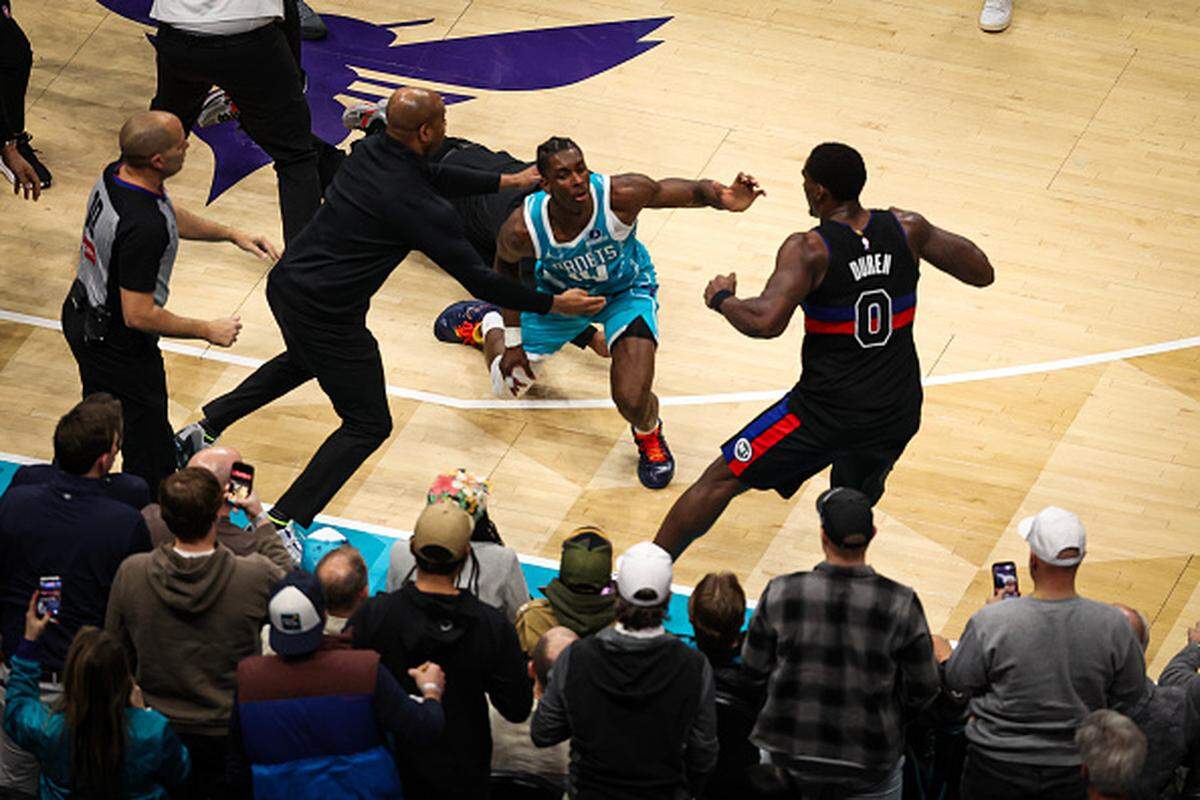 Moussa Diabate #14 and Miles Bridges #0 of the Charlotte Hornets fight Jalen Duren #0 of the Detroit Pistons during the second half of a basketball game at Spectrum Center on Feb..
