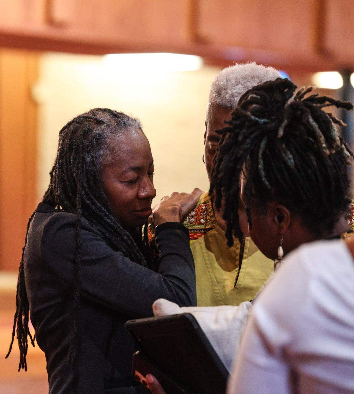 Rev. Glencie Rhedrick, Charlotte Clergy Coalition for Social Justice, left, provides comfort to a friend after the interfaith prayer vigil at Little Rock AME Zion in Charlotte on Tuesday, April, 30, 2024.