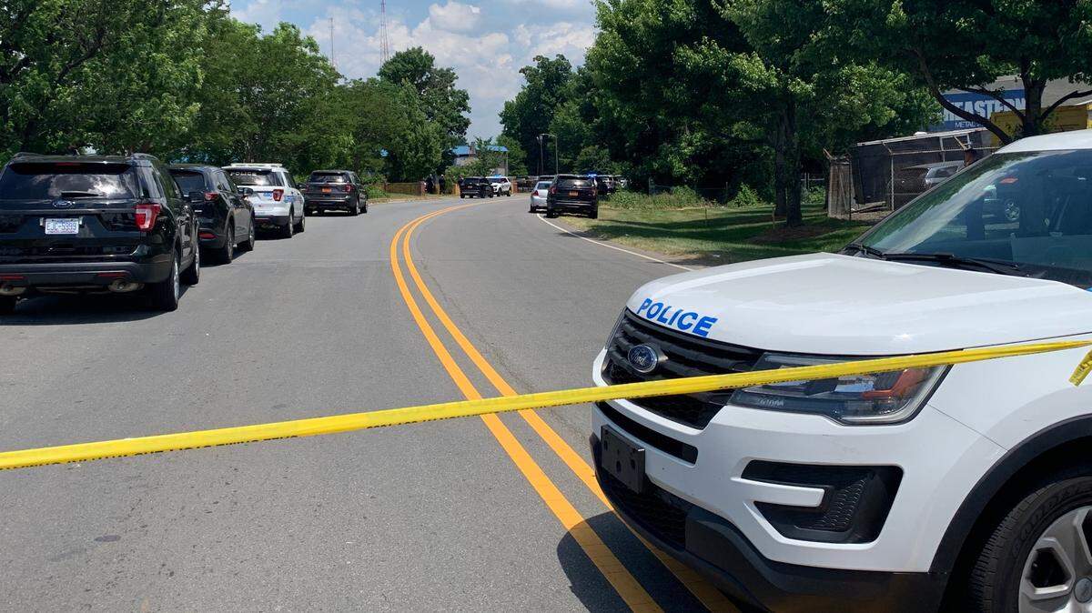 Police tape closes the area around a Budget Inn hotel on Thursday, May 27, 2021. A jury in June 2024 convicted a man who shot at a CMPD officer.
