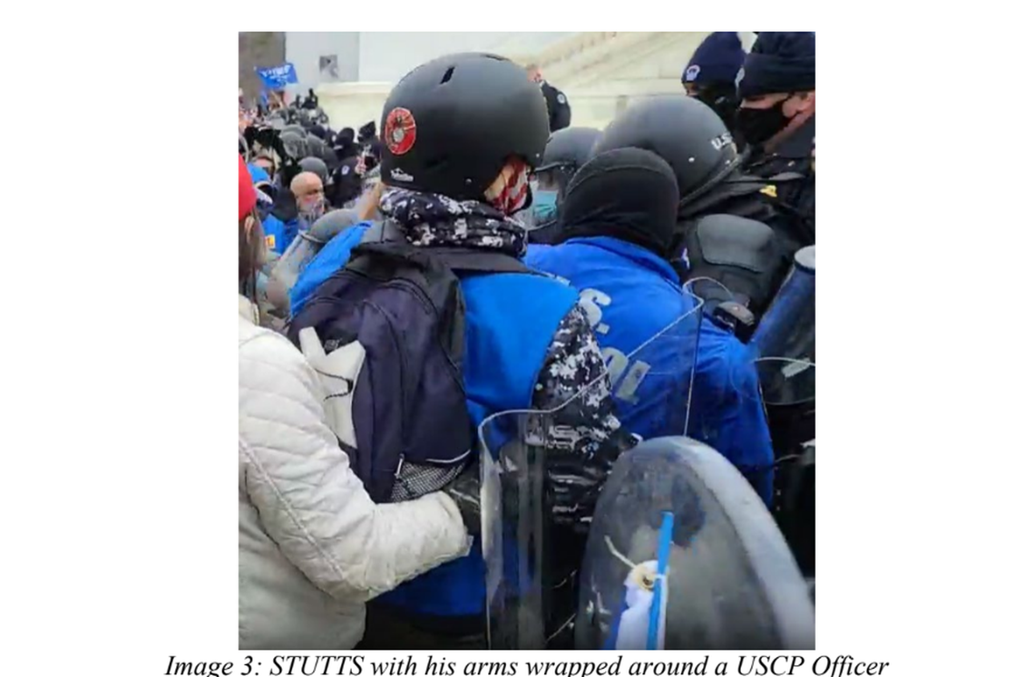 Lee Stutts wraps his arms around a U.S. Capitol Police officer in this image included in a criminal indictment affidavit charging Stutts with assaulting officers.
