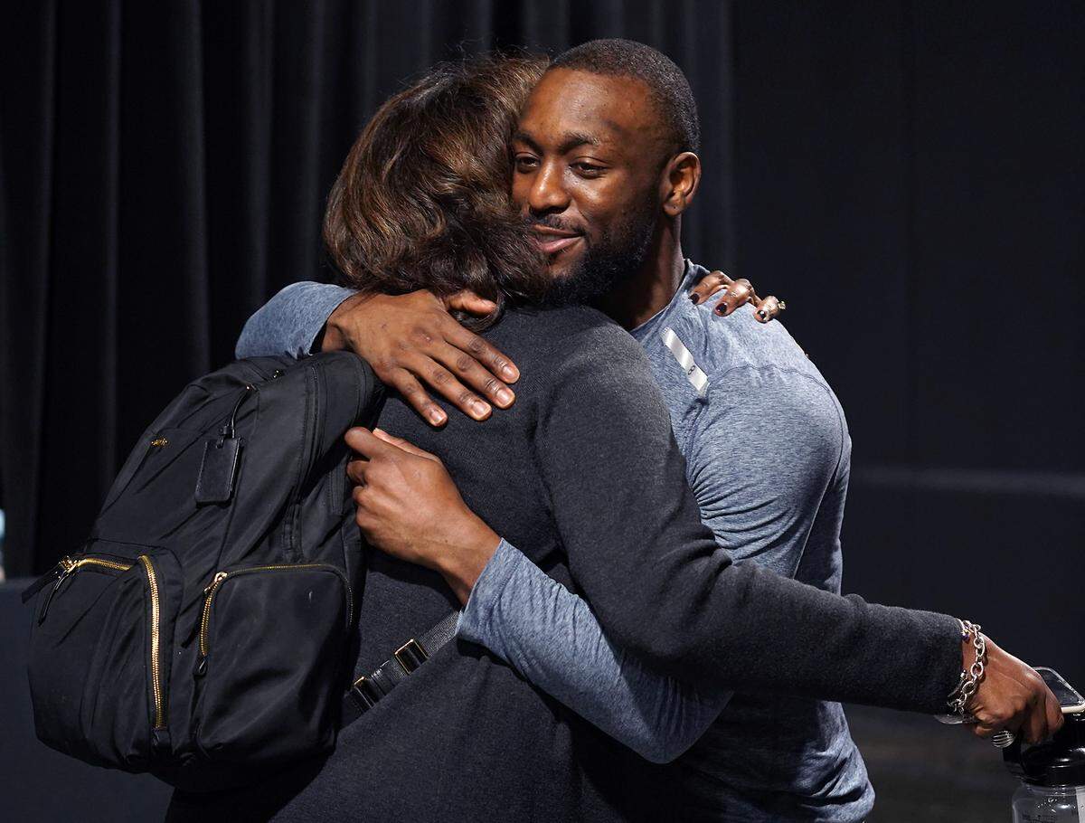 Boston Celtics guard Kemba Walker, right, embraces a friend following the team’s game against the Charlotte Hornets Thursday. The Celtics defeated the Hornets 108-87.