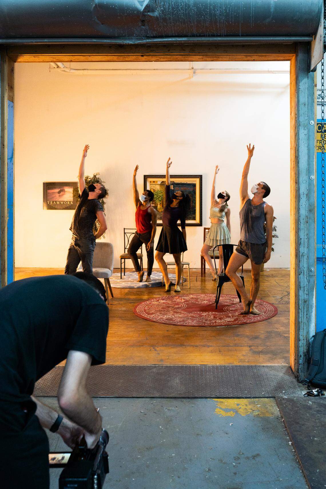 Filming for one portion of Helen Pickett’s “Home Studies, part III” took place in July at a studio outside Charlotte. The piece is a collaboration between artists from three ballet companies. It was choreographed via Zoom and rehearsed at home, then shot in five different locations. Here, James Wiley is seen filming Charlotte Ballet dancers (L to R): James Kopecky, Maurice Mouzon Jr., Raven Barkley, Sarah Lapointe, and Josh Hall.