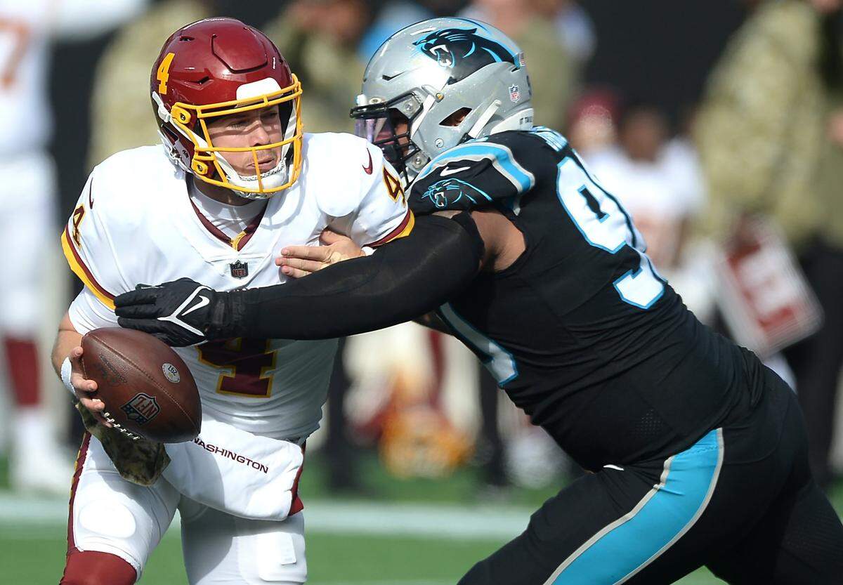 Carolina Panthers defensive tackle DaQuan Jones, right, sacks Washington quarterback Taylor Heinicke, left, during second quarter action at Bank of America Stadium in Charlotte, NC on Sunday, November 21, 2021. Washington defeated the Panthers 27-21.