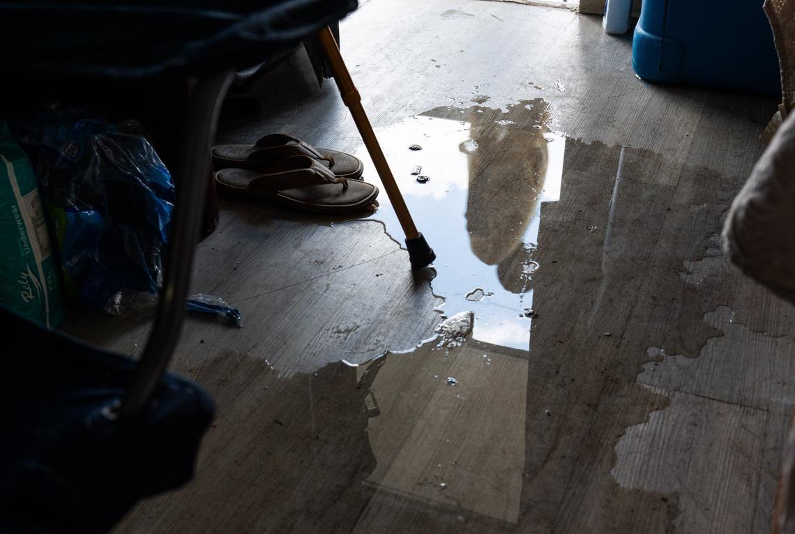 Water from one of the neighbor’s broken pipes is seen in Ellen Miller and Eveco Haggins’s room at the Lamplighter Inn on June 21, 2024.