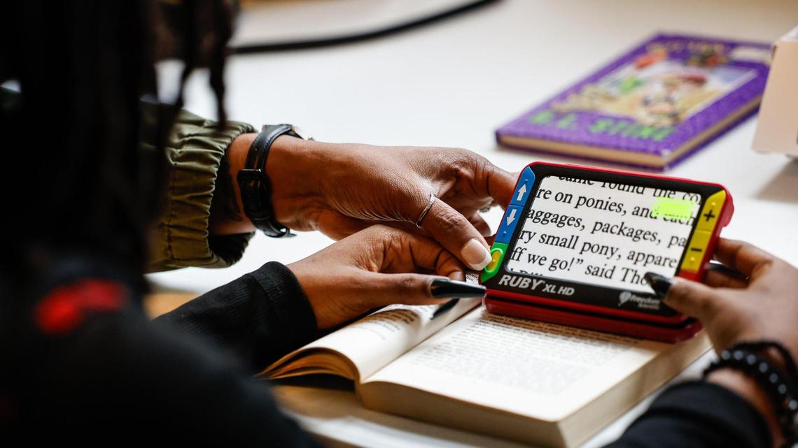 Nyla Wallace receives instruction on how to use an electronic video magnifier on Thursday, March 28, 2024. The magnifier will allow Wallace to read her textbooks easier and is provided at no cost by Sight Savers America, a non-profit that identifies eye care needs of children.