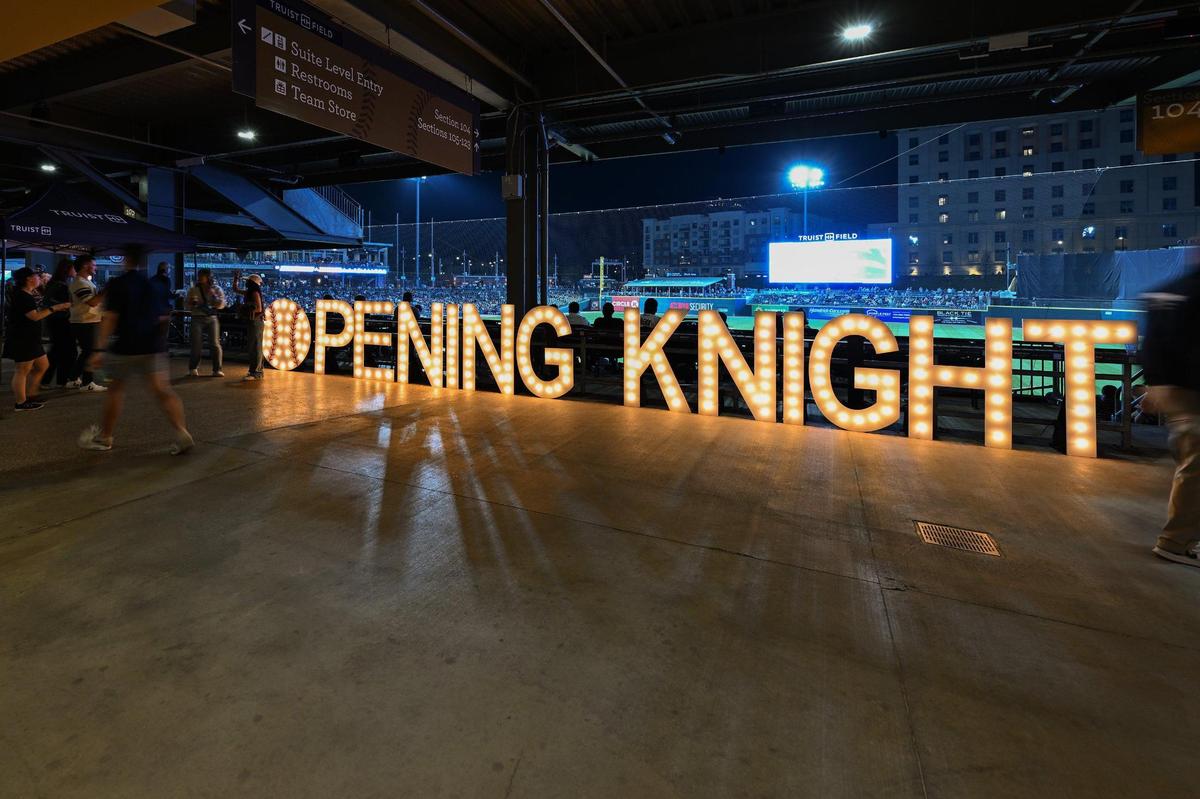 Fans travel the concourse during the fourth inning of a Minor League Baseball game between the Charlotte Knights and Gwinnett Stripers at Truist Field, Friday, March 28, 2025, in Charlotte, N.C. (Charlotte Observer/Matt Kelley)
