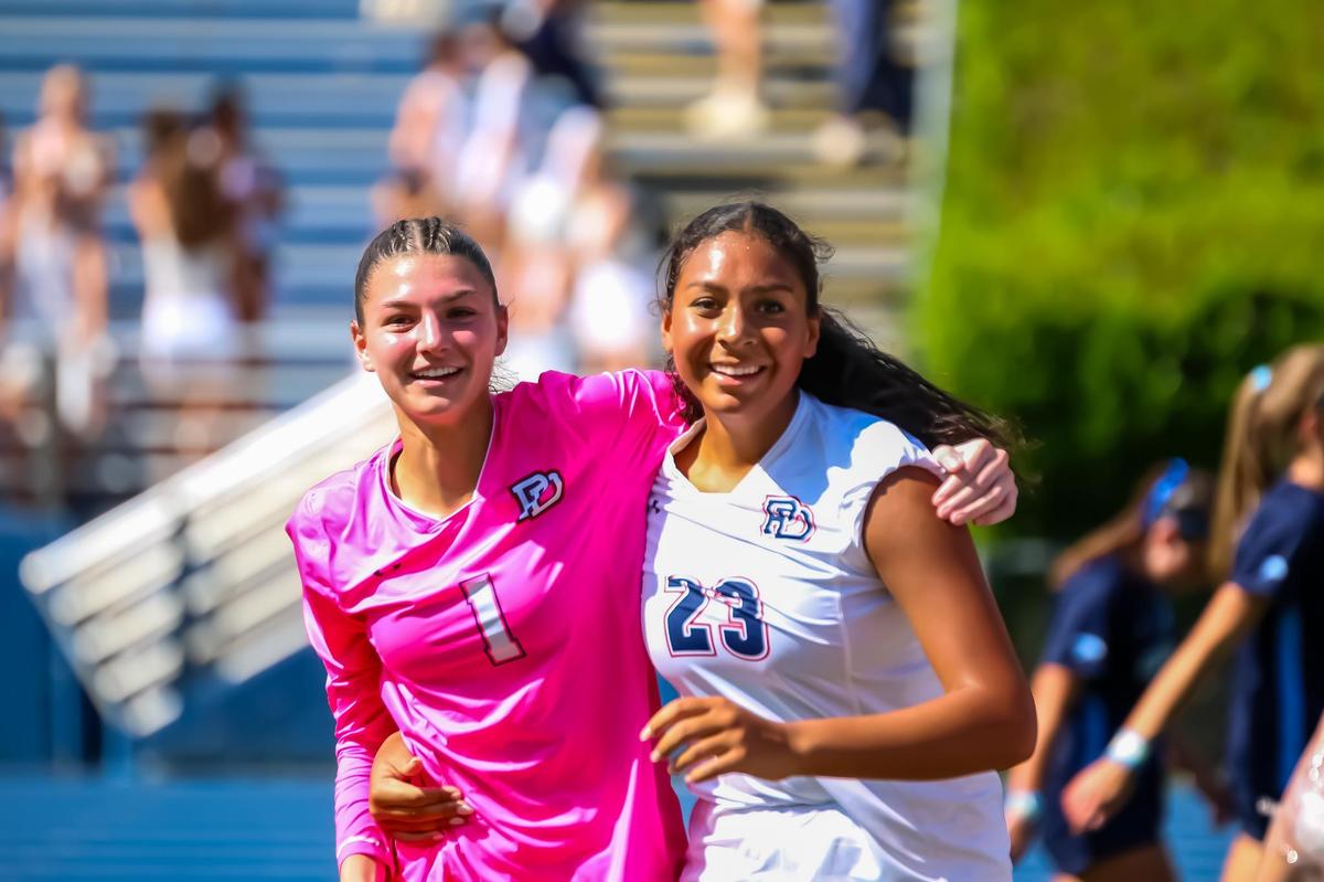 Providence Day, Moll DeBlitz (left) and Zuri Daniel’s head off the field together, the weight of victory finally sinking in under the stadium sun at the NCISAA girls soccer championship m at Charlotte Latin high school on May 17, 2025 in Charlotte, North Carolina