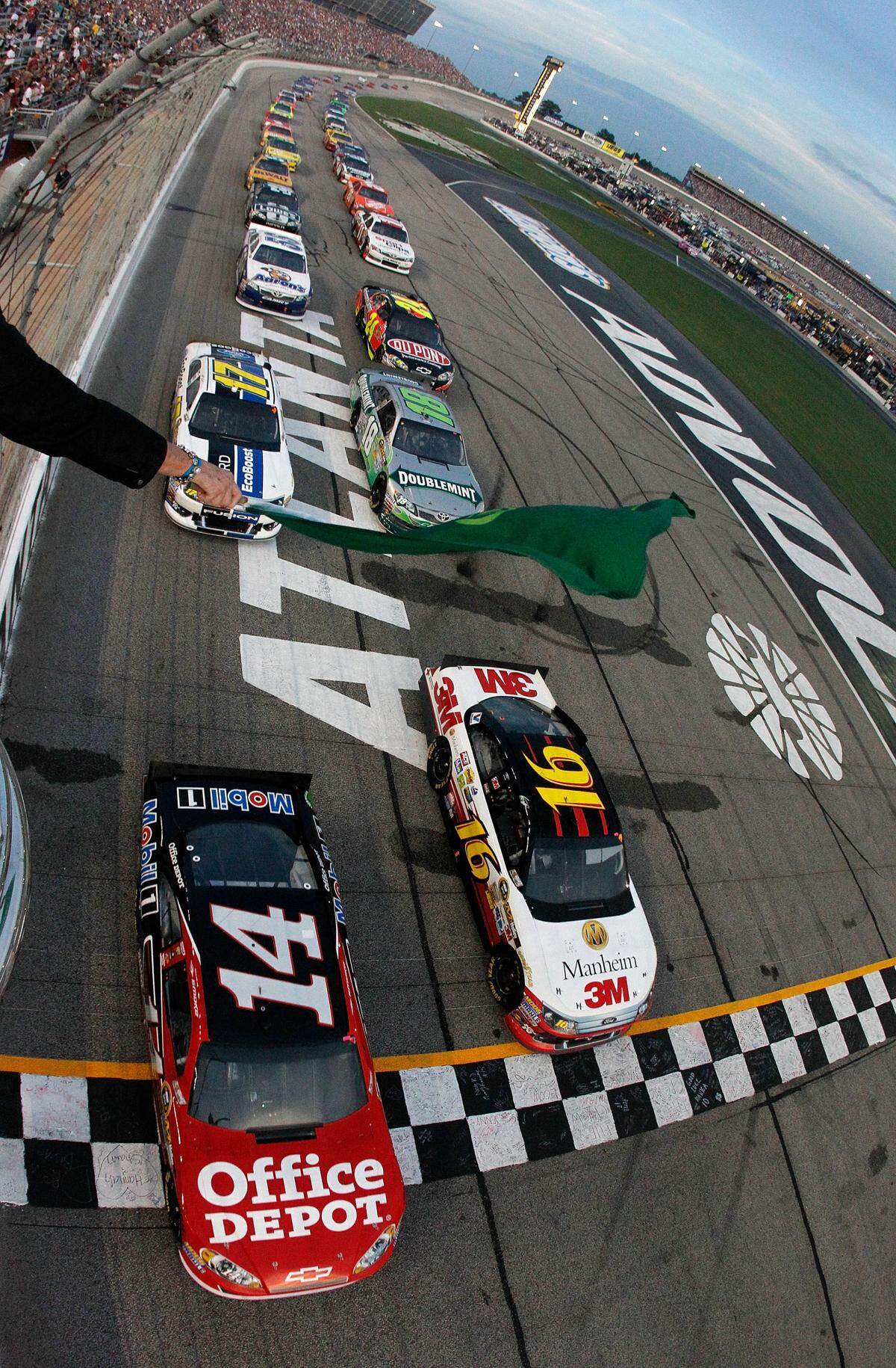 Tony Stewart, driver of the #14 Office Depot/Mobil 1 Chevrolet and Greg Biffle, driver of the #16 3M/Manheim Auctions Ford, lead the field at the start of the NASCAR Sprint Cup Series AdvoCare 500 at Atlanta Motor Speedway on September 2, 2012 in Hampton, Georgia. 