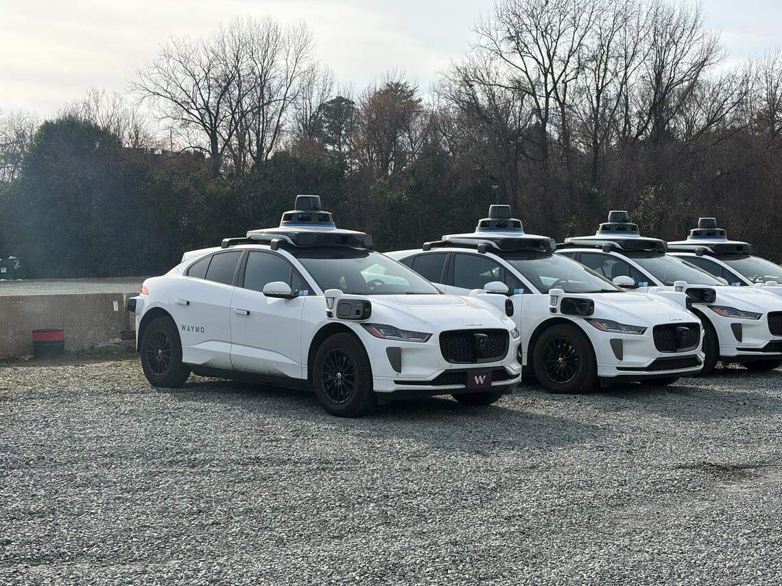 Driverless Waymo cars were seen at this gravel lot on McNinch Street in uptown Charlotte Tuesday.