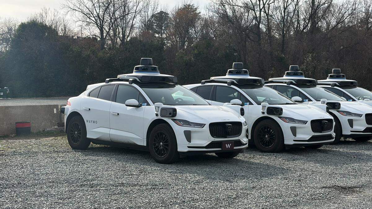 Driverlesss Waymo cars were seen at this gravel lot on McNinch Street in uptown Charlotte Tuesday.