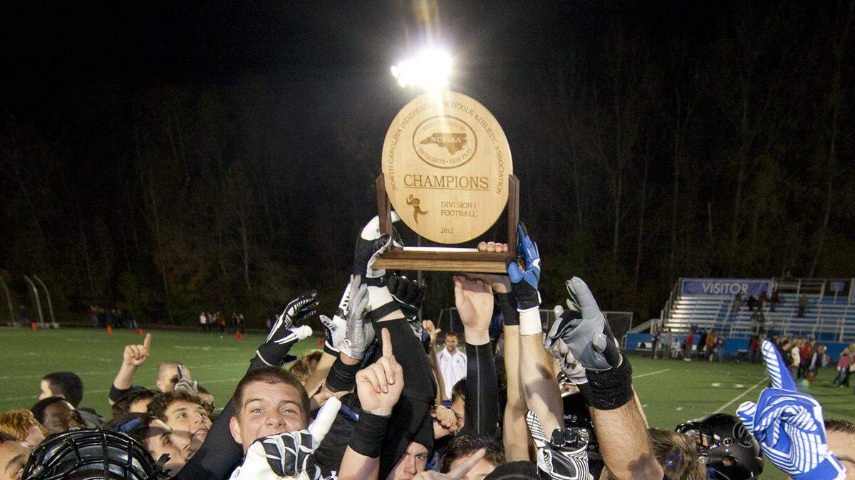 The Charlotte Christian Kinghts football team hoists the championship trophy after defeating Providence Day at the N.C. Independent Schools championship football game Friday, November 9, 2012 at Charlotte Christian School in Charlotte, NC. The Knights won 24 - 21. Photo by JASON E. MICZEK - www.miczekphoto.com