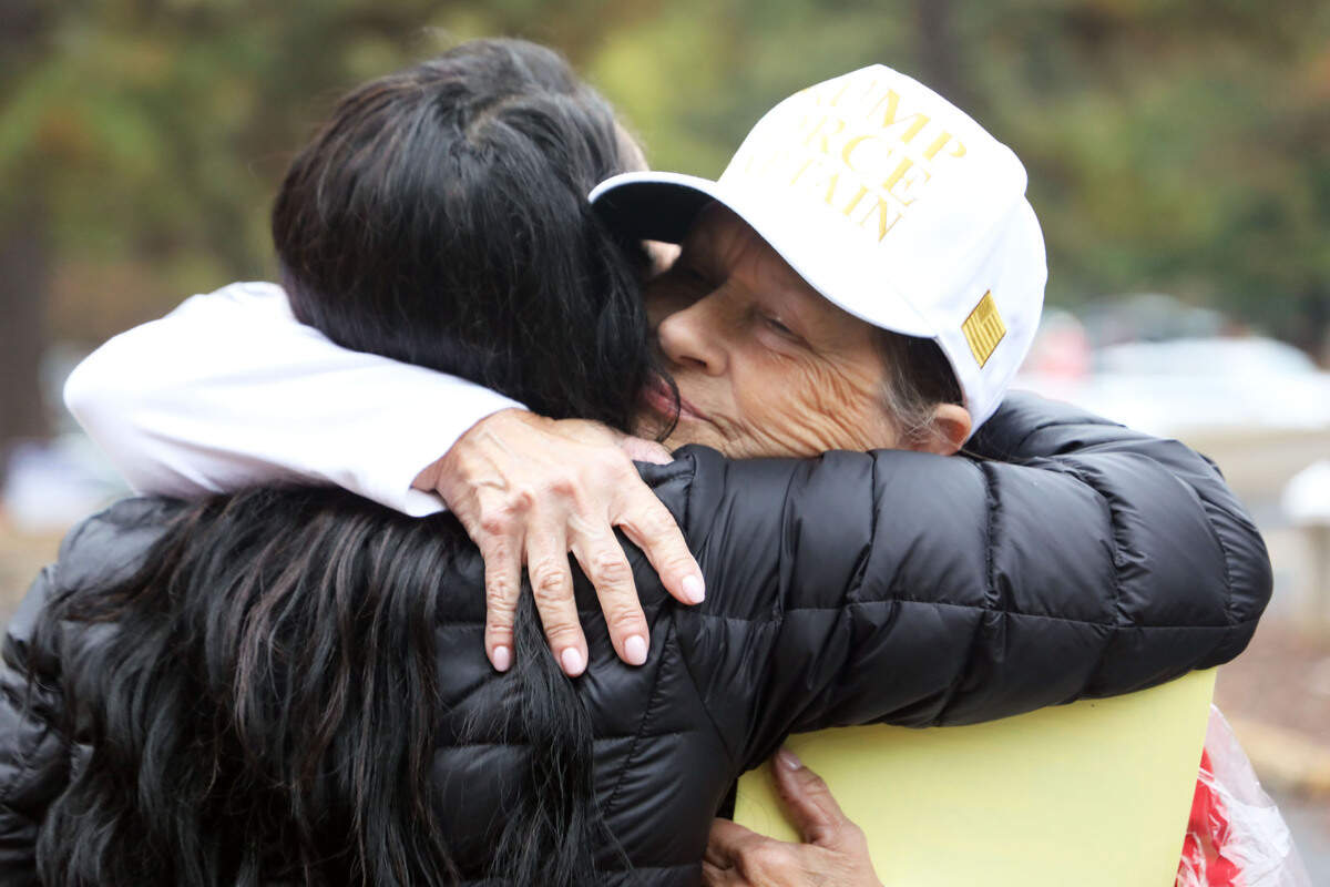 Dee Worley, a former national gymnastics champion, hugs fellow Republican campaign volunteer Deena Reagan before she heads off to work on Tuesday, November 5, 2024, at Huntersville Elementary School, 200 Gilead Road, Huntersville, N.C.