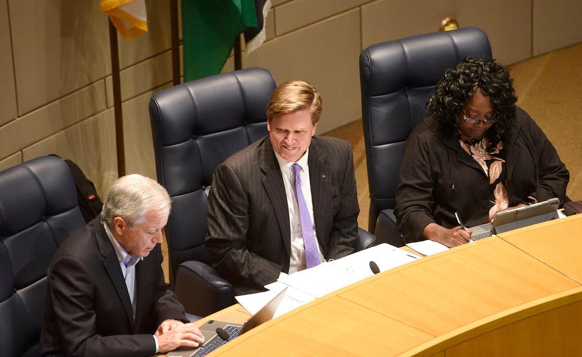 Flanked by Council members , Edmund Driggs (left) and LaWana Mayfield (right) Edwin Peacock III took his seat last month after he was sworn in to finish out Tariq Bokhari’s Charlotte City Council term, set to end in early December.