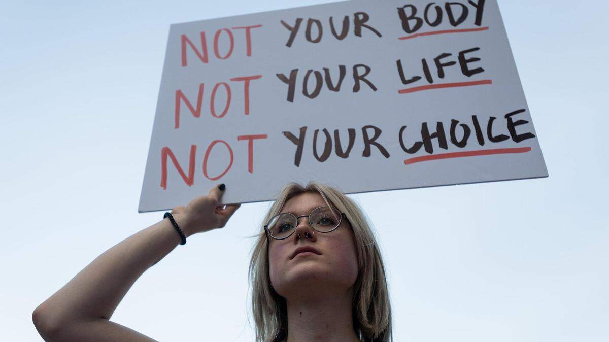 Kirsty Zubko, 20, holds a sign as speakers addresses abortion-rights demonstrators gathered in uptown Charlotte on June 24, 2022 to protest the Supreme Court’s decision to overturn Roe v. Wade.