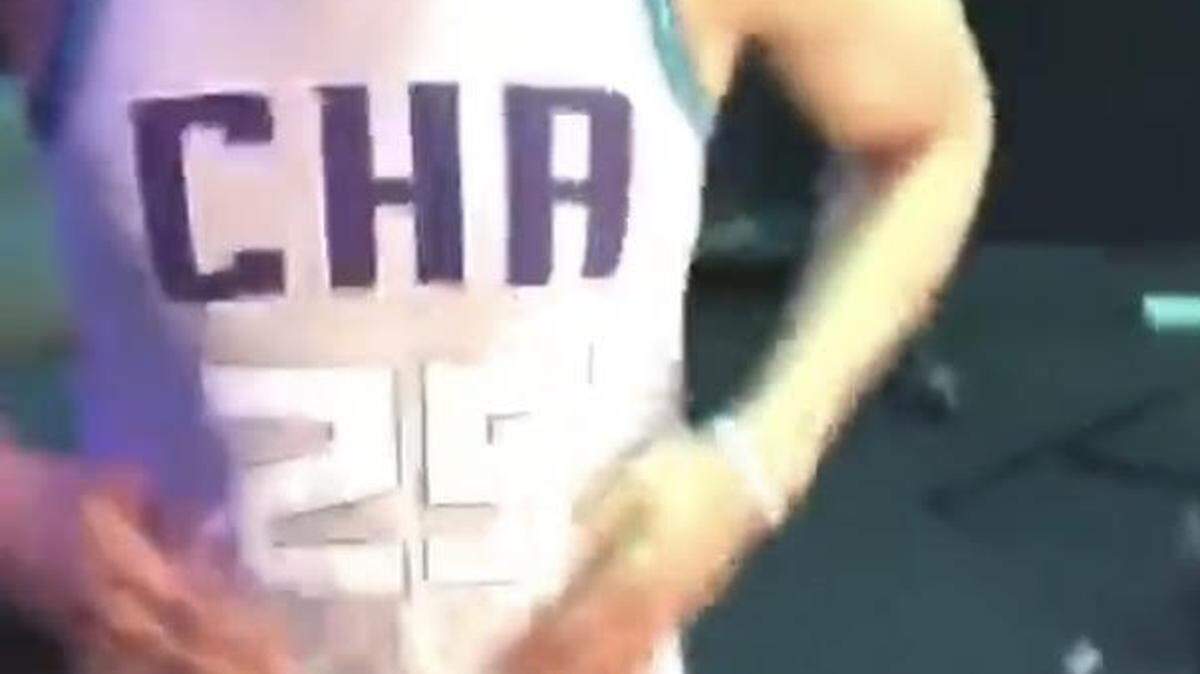 Charlotte Hornets player PJ Washington poses for teammate Miles Bridges in what appears to be a new team un
