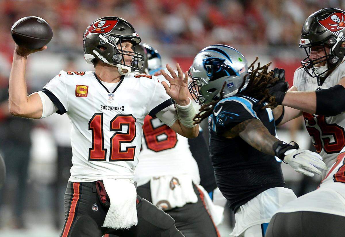 Tampa Bay Buccaneers quarterback Tom Brady stands in the pocket passing as the Carolina Panthers defense rushes during third quarter action at Raymond James Stadium in Tampa, Fl. on Sunday, January 9, 2022. The Panthers lost to the Buccaneers 41-17.