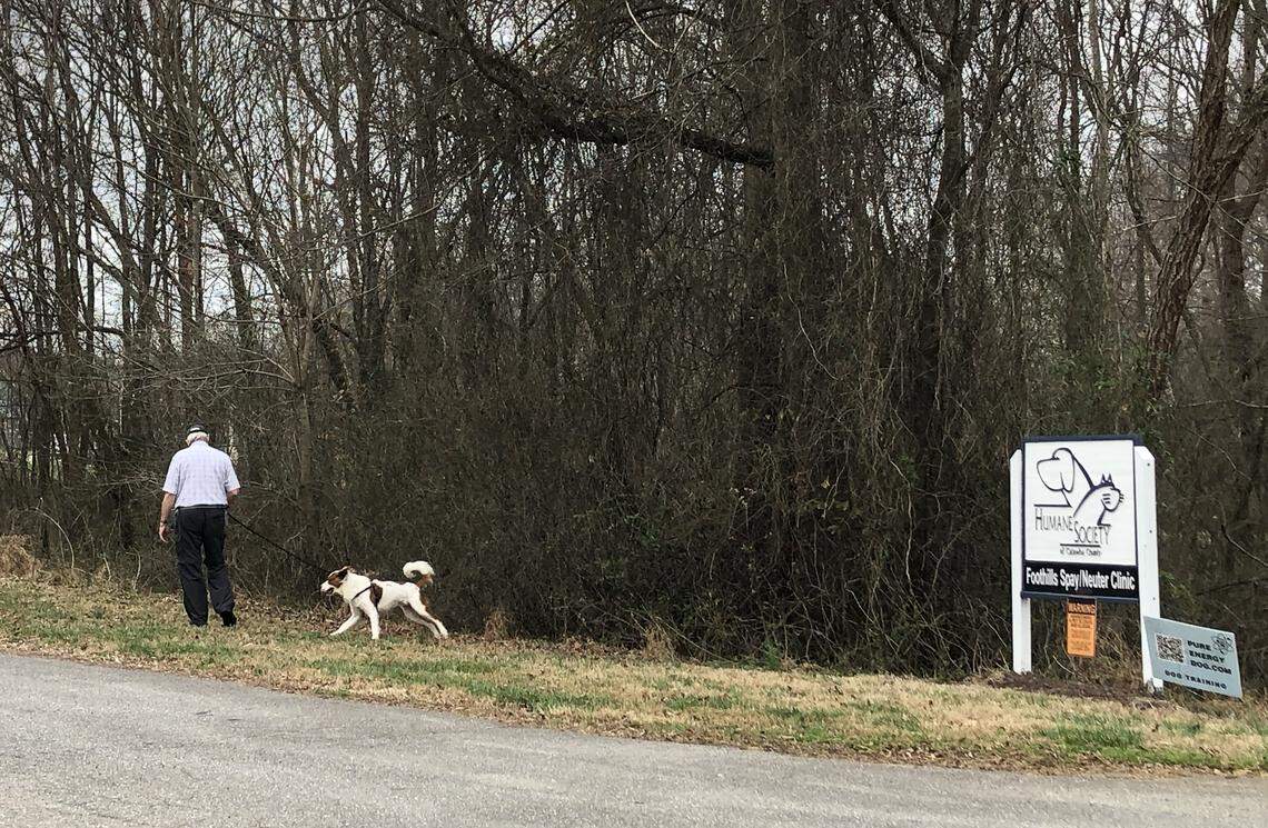 A man walks a dog outside the Humane Society of Catawba County near Newton.