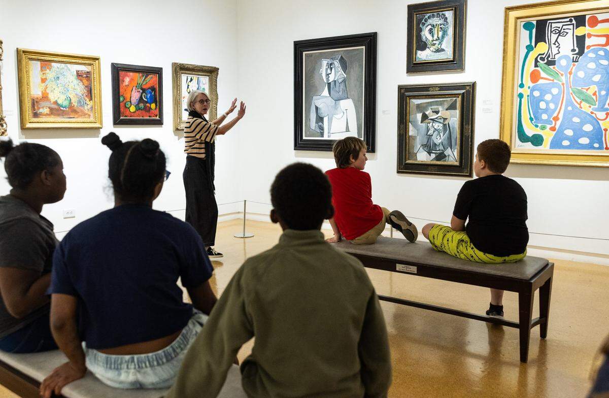Jenny Hubbard, Waterworks Visual Arts Center gallery attendant talks to Hanford-Doyle Elementary School fifth-graders about the “Never Before Seen...Modern Masterpieces” at Waterworks Visual Arts Center in Salisbury, N.C., on Tuesday, November 19, 2024.