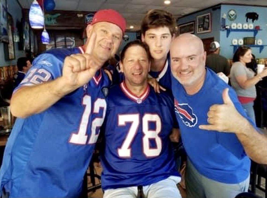 At Taste of Buffalo Pizzeria in Huntersville, Jamie Seitz would often wear his Buffalo Bills gear. Also pictured, from left to right: Jamie’s brother Denny Seitz, his son Carter Seitz and friend Chad Kirkby.