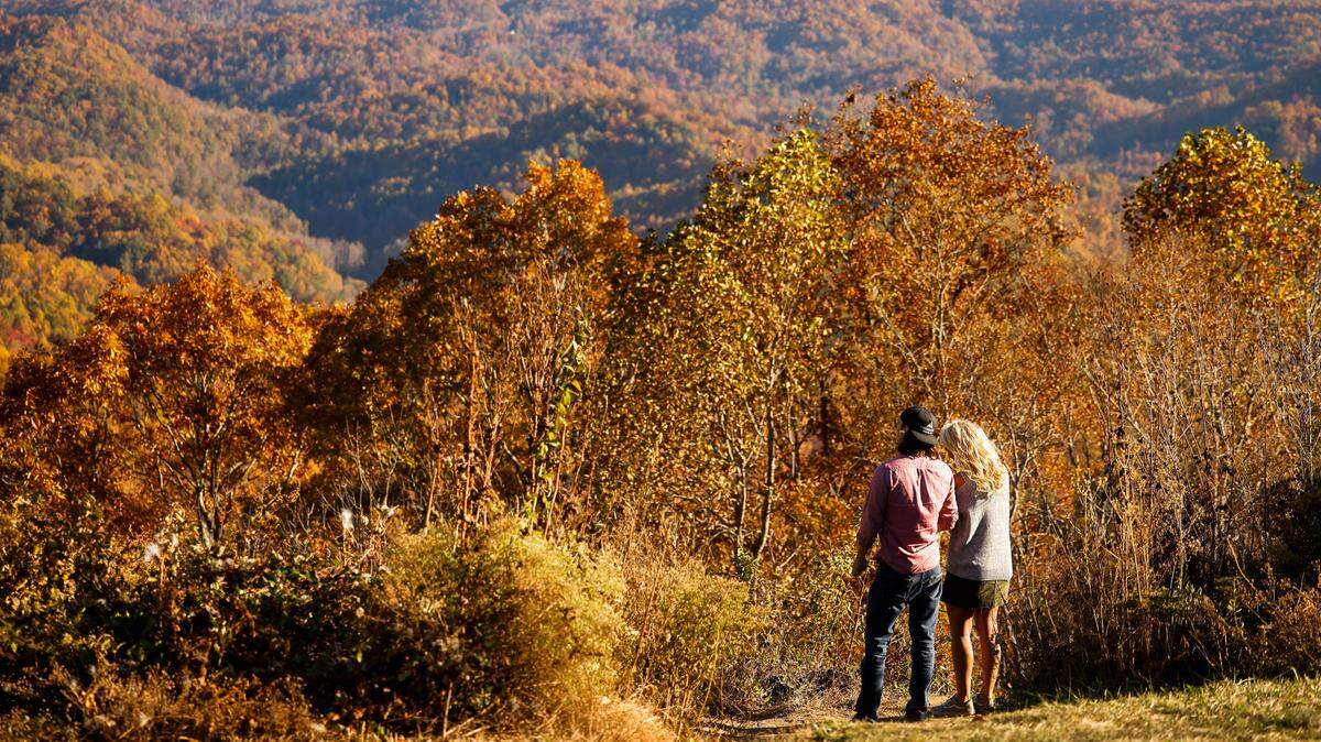 Caleb Dennis, of High Point, N.C., and Renita Matson, of Asheboro, N.C., take in the Fall foliage from Grandview Overlook along the Blue Ridge Parkway in Boone, N.C., Monday, Oct. 24, 2022.