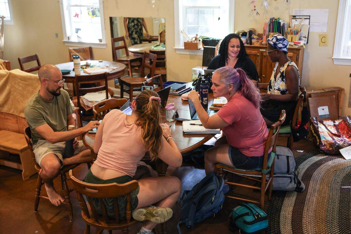 Staff at ALC Mosaic, a private school located on Monroe Road, have a meeting in one of the school’s classrooms on Monday.
