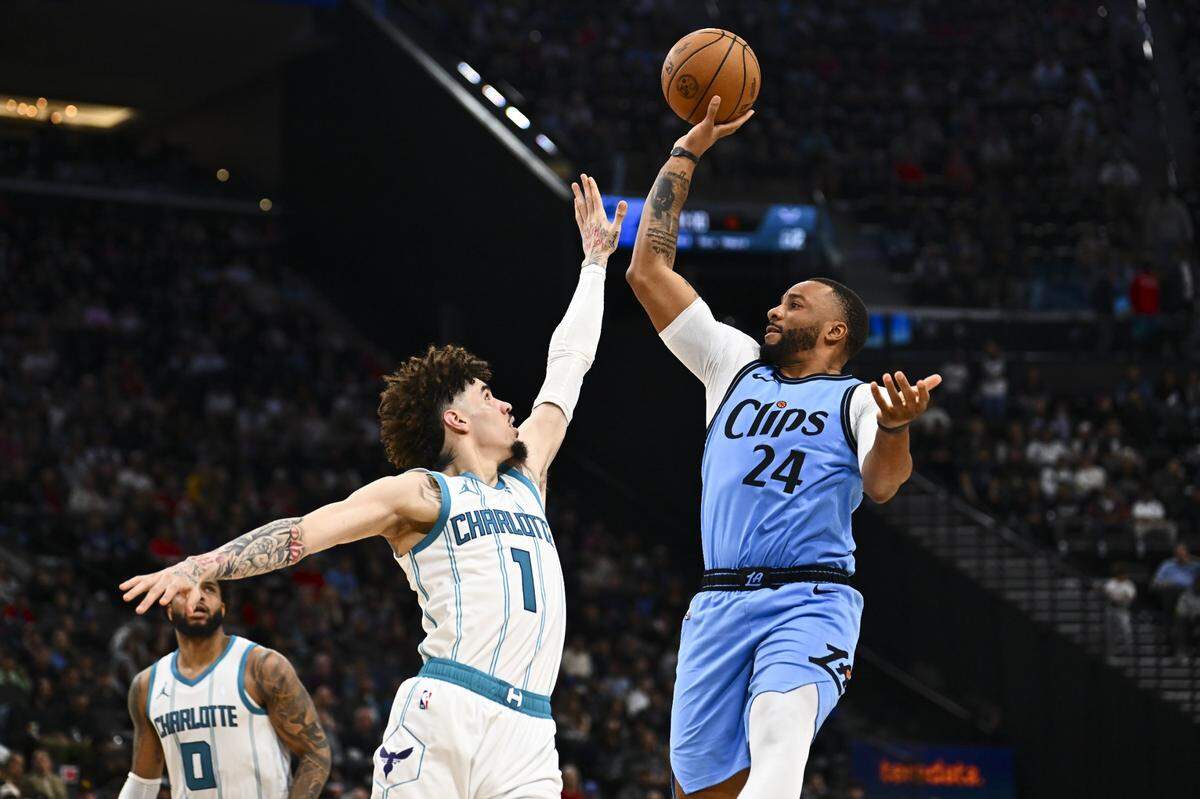 LA Clippers guard Norman Powell (24) shoots the ball against Charlotte Hornets guard LaMelo Ball (1) during the second half at Intuit Dome.