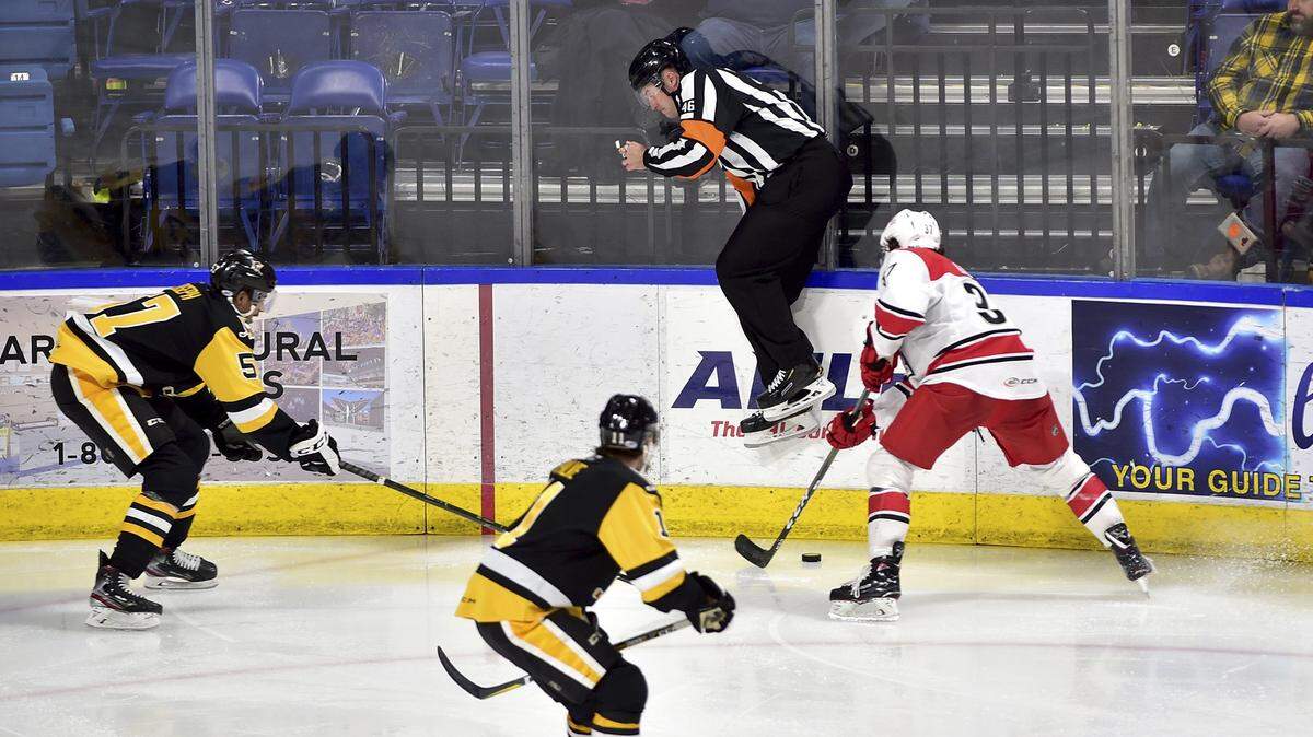 An official jumps over the puck controlled by Charlotte Checkers right wing Dave Gust during the team’s AHL hockey game against the Wilkes-Barre/Scranton Penguins earlier this month. Last weekend, Charlotte dropped two games at home to the Penguins.