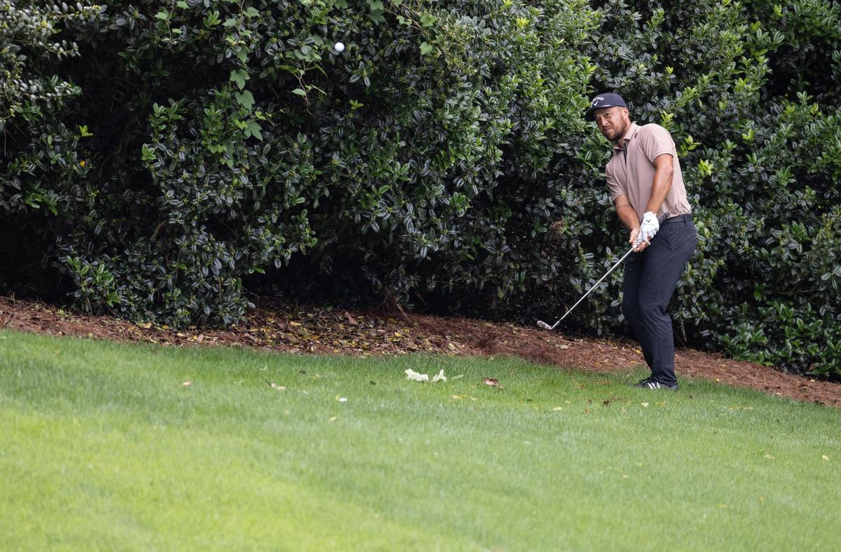 Xander Schauffele hits on the 8th hole after losing his ball in the woods during round one of the Wells Fargo Championship at Quail Hollow Club in Charlotte, N.C., on Thursday, May 9, 2024.