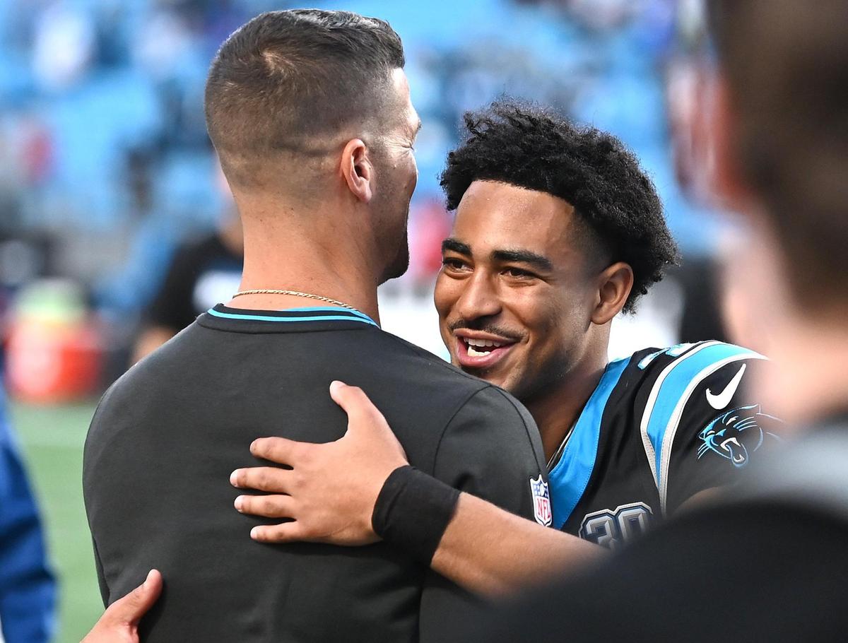 Carolina Panthers head coach Dave Canales, left, and quarterback Bryce Young, right, hug following the team’s 23-22 victory over the New Orleans Saints at Bank of America Stadium in Charlotte, NC on Sunday, November 3, 2024.