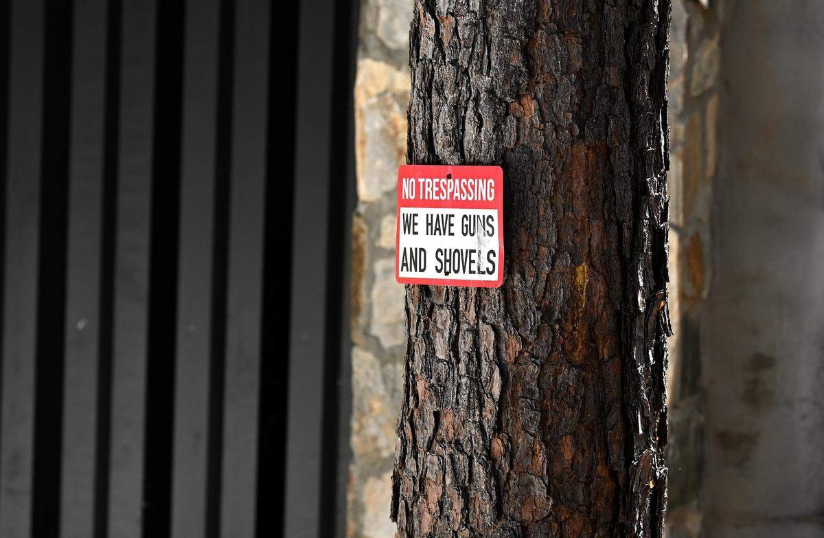 A “No Trespassing” sign posted outside the home of Charlotte rapper DaBaby in Troutman, NC says “We have guns and shovels.” DaBaby’s home was the scene of a shooting on Wednesday, April 13, 2022.