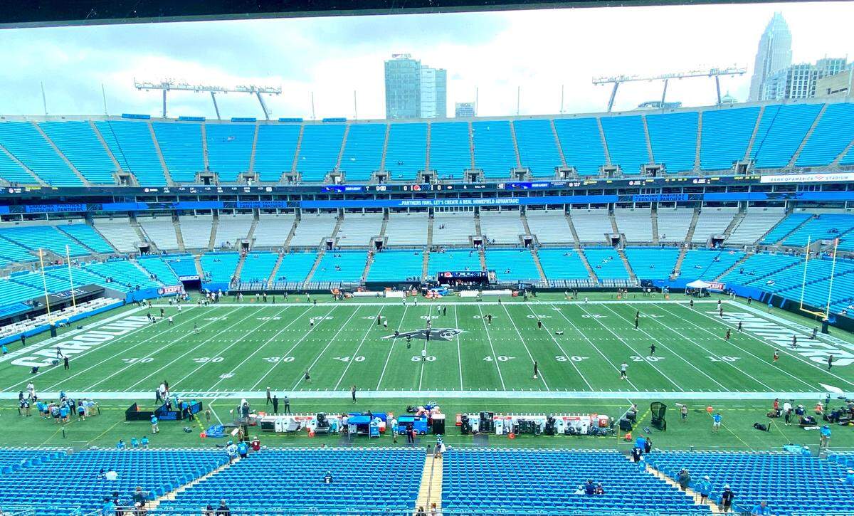 The Carolina Panthers’ modified on-field paint scheme due to weather concerns is a plain black-and-white theme, both at midfield and int he end zones.