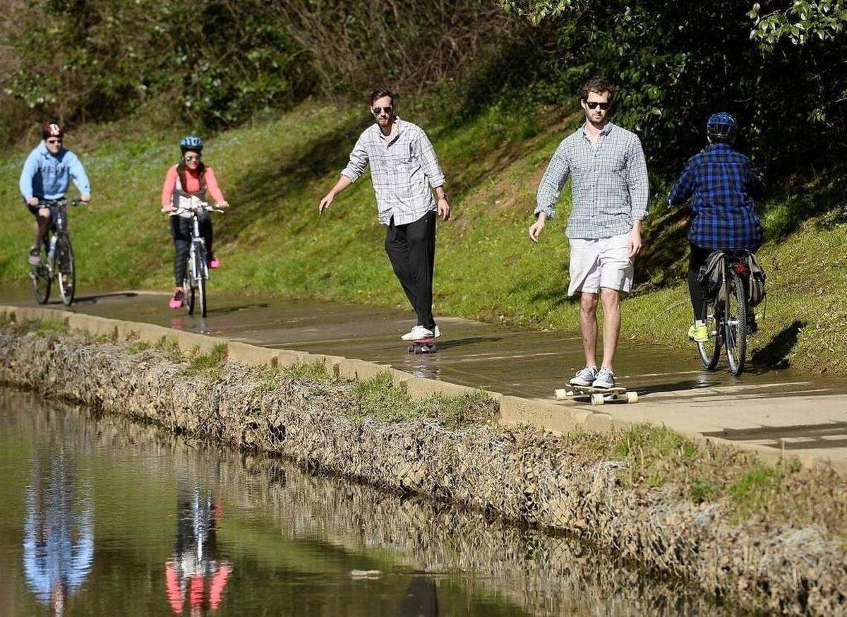 Skateboarders navigate Little Sugar Creek Greenway.