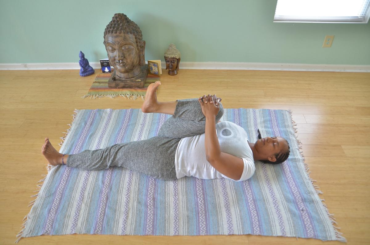 Yoga teacher Keisha Battles demonstrates strong-wind-relieving yoga pose.