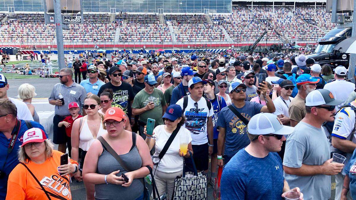 NASCAR fans mingle around pit road and behind the pit boxes at the Coca-Cola 600 on Sunday, May 29, 2022 at Charlotte Motor Speedway.