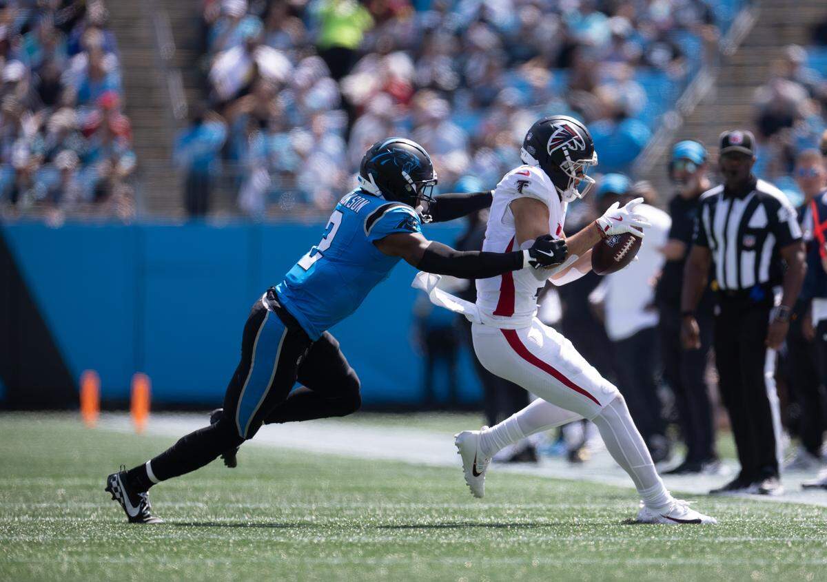 Carolina Panthers cornerback Mike Jackson, left, tackles Atlanta Falcons wide receiver Drake London on Sunday at Bank of America Stadium in Charlotte on Sunday, Sept. 21, 2025