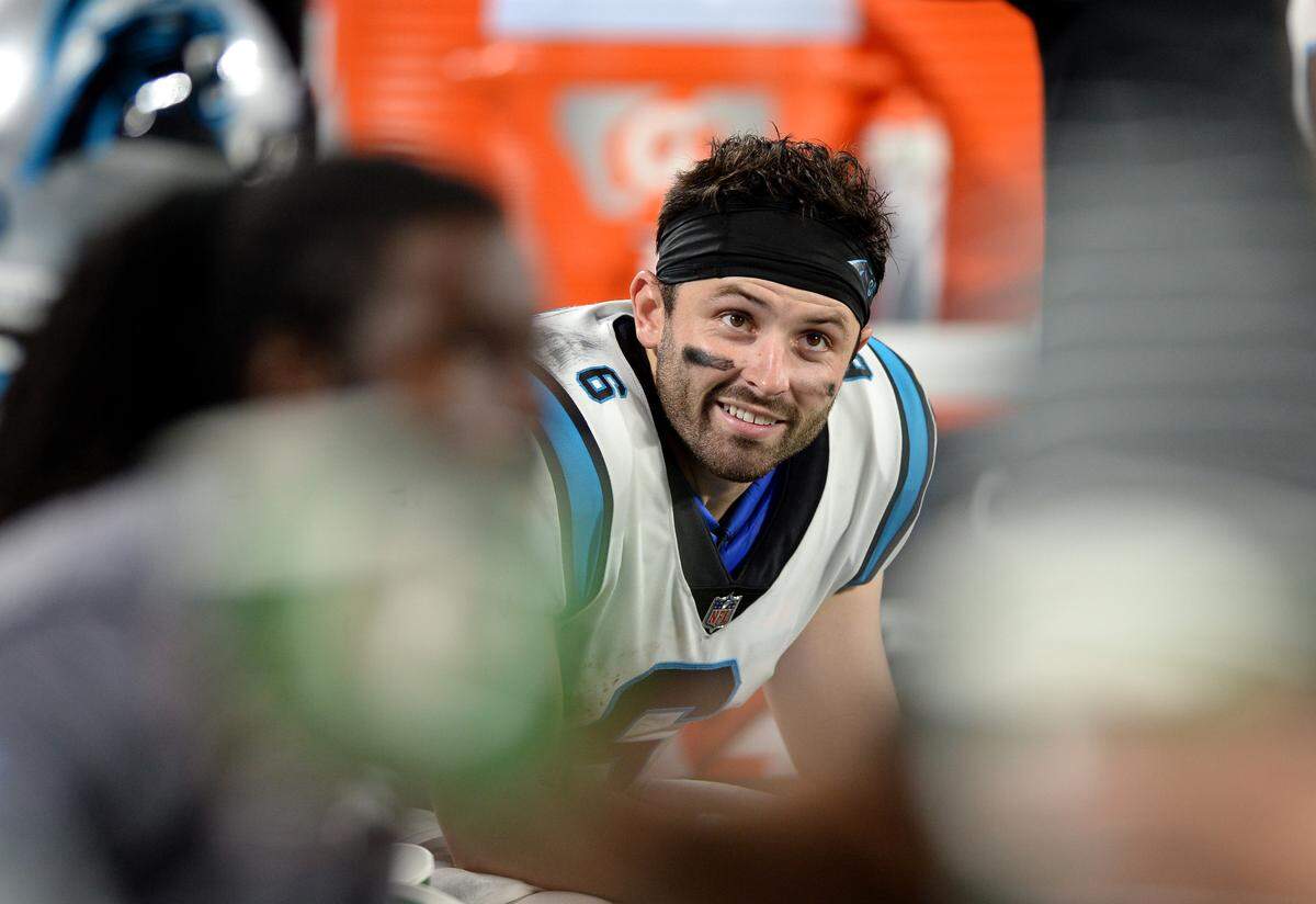 Carolina Panthers quarterback Baker Mayfield smiles as he sits on the team’s bench during action against the Buffalo Bills at Bank of America Stadium in Charlotte, NC on Friday, August 26, 2022.