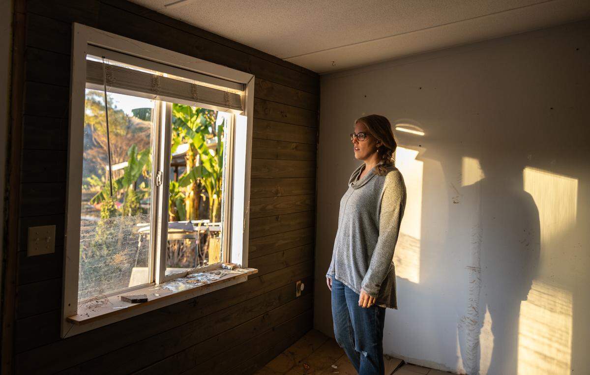 Jennifer Kleine-Jaeger gazes at the Catawba River through the window of her flood-damaged Lake Drive home last November.